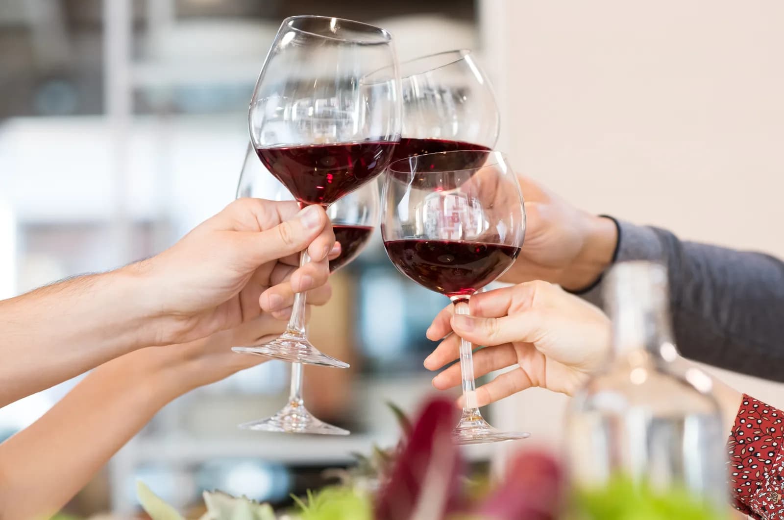 Friends toasting with glasses of red wine