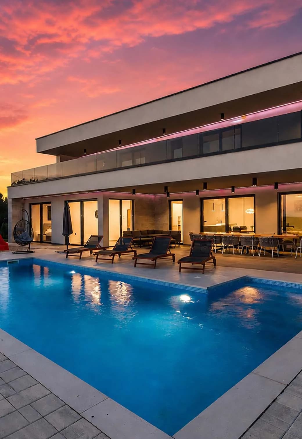 Modern villa with pool at sunset